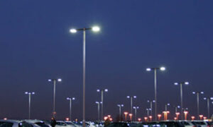 Lighted street lights in parking lot at a time