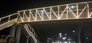 LED-lit pedestrian overpass at night in the Philippines